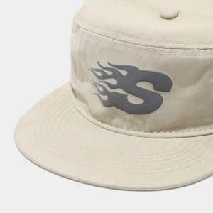 Detail of American street style beige flat top cap with embroidered S letter and stitching