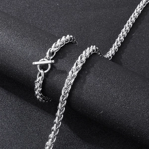 Detailed macro view of silver spiga chain necklace with decorative T-bar toggle clasp