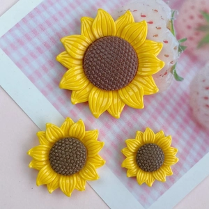 Three glossy yellow resin sunflower charms for DIY crafts and hair accessories