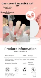 Detail of French pink gradient press-on nails with plaid patterns and 3D heart charms