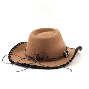 Detail of brown wool cowboy hat with black braided brim edge and wooden bead accents
