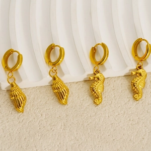 Golden stainless steel hoop earrings with seahorse and seashell charms in ocean style