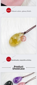 Macro shot of natural teardrop amethyst and citrine pendants on a white fur background