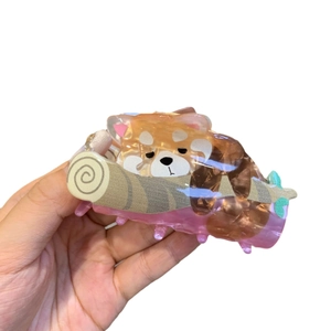 Cartoon red panda claw clip made of acrylic acetate shown in a creative sleeping pose