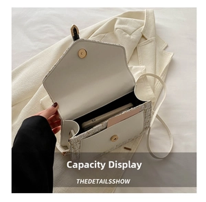 Internal view of tweed crossbody bag showing spacious main compartment and card slot