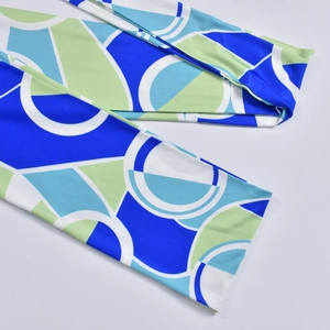 Detail of fabric stitching and blue abstract geometric pattern on a halter top
