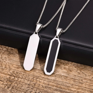 Detail of polished stainless steel bar pendants with black enamel on a box chain