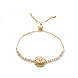 Detail of adjustable gold-finish daisy bracelet with pearl center and sparkling zircons