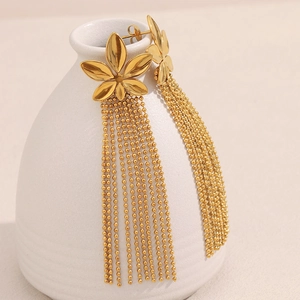 Close-up of 18K gold plated flower earrings with elegant metallic bead chain tassels