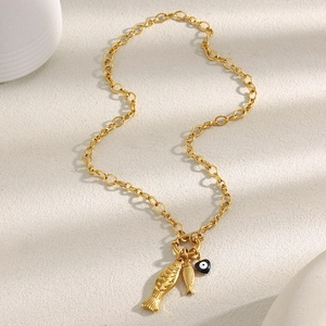 Detail of 18K gold plated chain necklace with two fish pendants and one heart charm