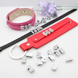 Detail of 8mm chrome DIY alloy numbers with rhinestones on colorful leather bracelets