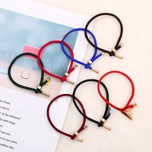 Close-up of elastic hair ties with gold metal cylinders in six assorted colors