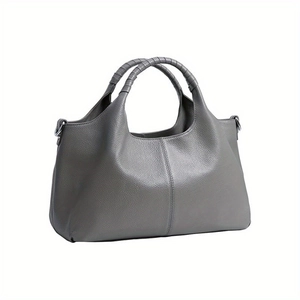 Grey textured leather tote bag with unique woven handles on a clean white background