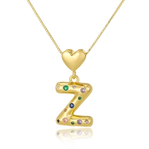 Detailed close-up of golden heart pendant with letter Z and colorful zircon inlay