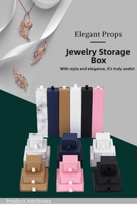 Various drawer-style jewelry gift boxes in marble, pink, and navy for necklaces and rings