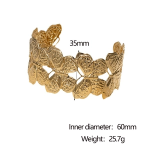 Detail showing the 35mm wide golden butterfly cuff bangle with detailed metal textures