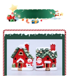 Close-up of ceramic Christmas house figurines with Santa Claus, Snowman and LED cutout stars