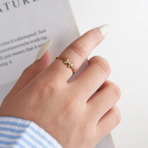 Elegant gold S925 sterling silver bow ring with diamond accent on model's hand