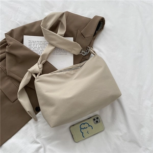 Japanese style beige canvas crossbody bag with knot shoulder strap and chain detail