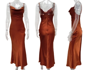 Detailed close-up showing the sleek satin texture and cowl neck design of the orange slip dress