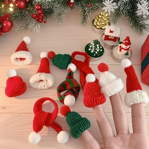 Miniature Christmas knit hats and scarves on wood background for festive decorations