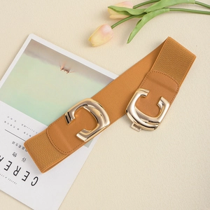 Detail of tan elastic wide waist belt with premium polished gold C-shape buckle