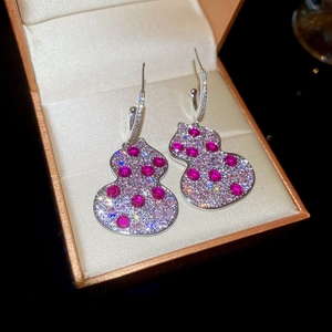 Detailed view of gourd earrings with colorful inlaid zircons and silver finish