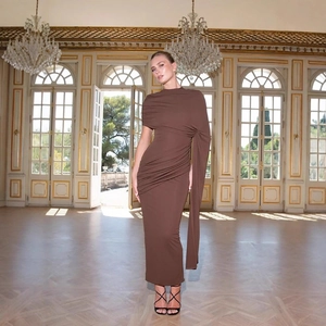 Detail des eleganten braunen One-Shoulder-Maxikleids mit Falten und modischem langen Cape