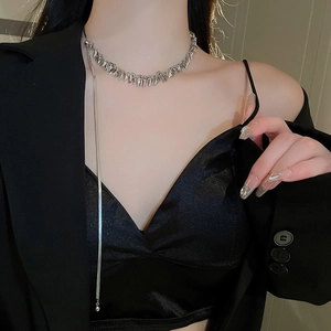 Close-up of silver sequin fringe necklace with elegant dangling chain on model