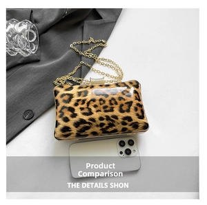 Detailed comparison of leopard print evening clutch size with a smartphone and chain