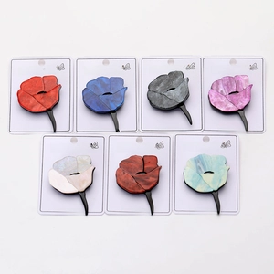 Flat lay of acrylic rose flower brooches in seven pearlescent colors on display cards