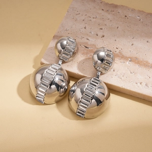 Detailed macro of silver geometric earrings with baguette-cut zircon in mirror polish