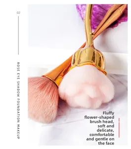 Macro view of soft rose-shaped makeup brush head with fluffy pink fiber bristles