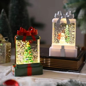 Detail of Christmas lantern gift boxes with internal LED light and flowing glitter