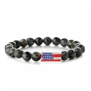 Detail of beaded bracelet with grey stone beads and American flag rectangular charm