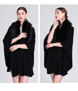 Detail of black knitted poncho cardigan featuring elegant faux fur collar and cape style