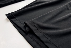Macro view of high-elastic black fabric with double-needle stitching on hemline