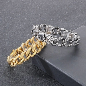 Close-up of vintage style steel chain bracelet featuring detailed fleur-de-lis engravings