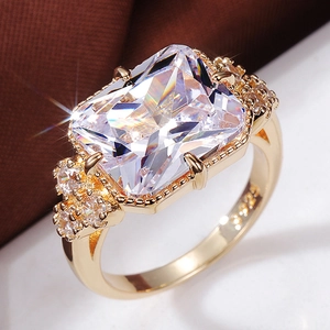 Bague élégante plaquée or avec zircon transparent taille radiant et pierres latérales