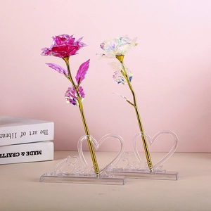 Detail view of pink and holographic gold foil roses on a clear heart-shaped Love base
