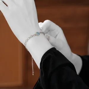Elegant silver bracelet with blue zircon flower and adjustable chain on female wrist