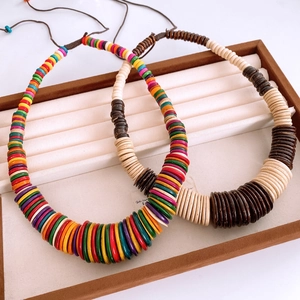 Detail of colorful and earth-tone wooden disc bead necklaces in a display box