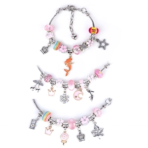 Detailed view of DIY charm bracelets with pink and silver ocean-themed beads and pendants