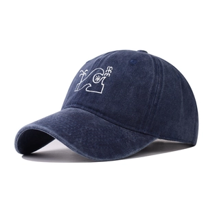 Detail view of washed navy baseball cap with white palm tree and wave embroidery
