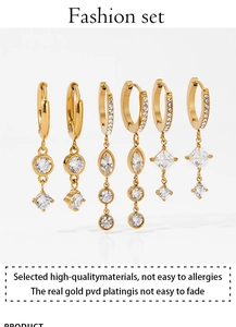 Detailed macro view of three gold PVD plated stainless steel zircon dangle earrings
