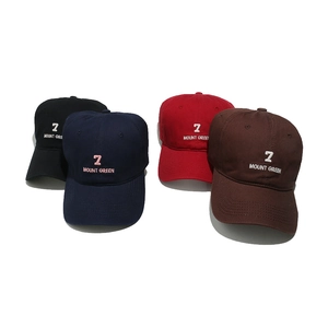 Set of four embroidered baseball caps in black, navy, red, and brown on white background