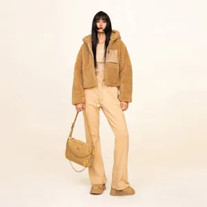 Close-up of brown plush hooded jacket with matching beige high-waist wide-leg trousers