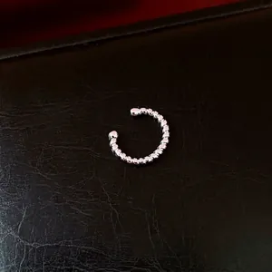 Minimalist silver-plated ear cuff with a unique twisted texture for non-pierced ears