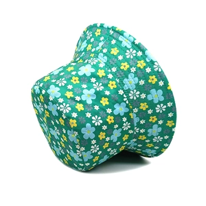 Detailed view of green floral bucket hat with multi-colored flowers and stitched brim