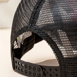 Detail of breathable black mesh material and adjustable snapback closure on a truck cap